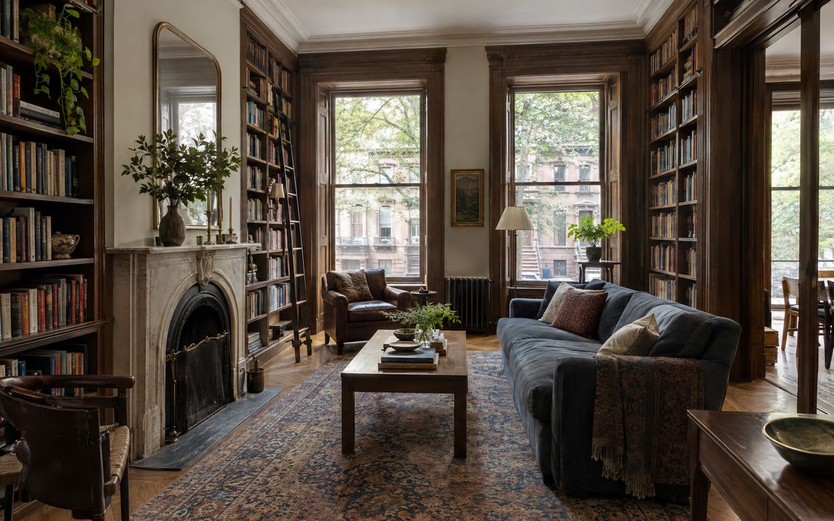 A Brooklyn Heights brownstone parlor with built-in bookcases to the ceiling and a fireplace, design concept
