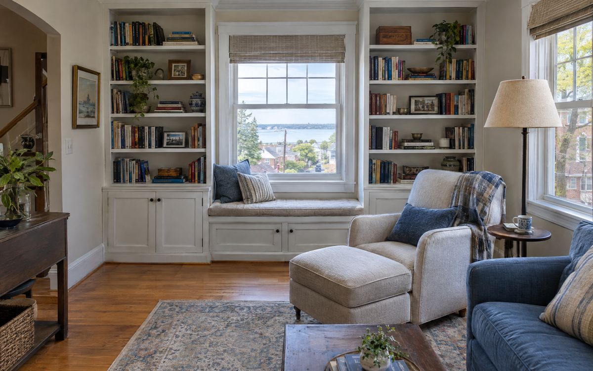 Built-in white bookcases around a window in a Staten Island family room, design concept